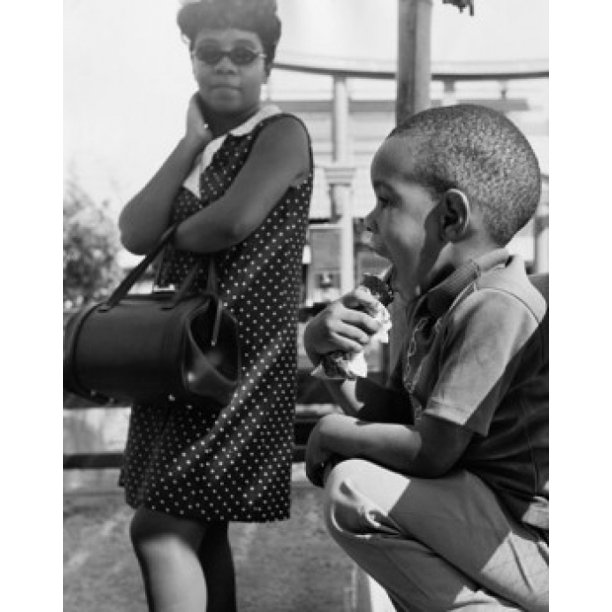 Son licking icecream with his mother looking at him Poster Print (24 x