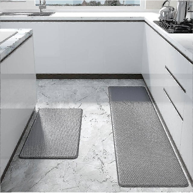 non skid waterproof kitchen mats anti-fatigue thick cushioned floor rug Alfombrillas de cocina antideslizantes y anti-fatiga, vista frontal con dos piezas: alfombra larga frente a la encimera y otra pequeña ante el fregadero; espuma PU acolchada de baja recuperación según la ficha, ribete cosido, tono gris y base antideslizante; fácil de limpiar.