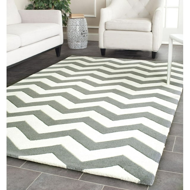 Safavieh Chatham Jake area rug featuring gray and white zigzag stripes, styled in a modern living room setting with neutral furniture.