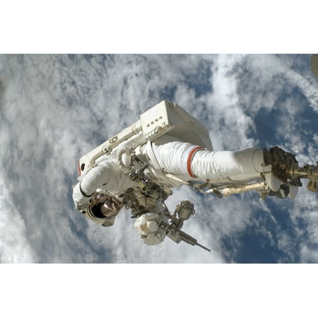 Anchored to a Canadarm2 mobile foot restraint an astronaut installs a spare-parts platform and tool-handling assembly for Dextre also known as the Special Purpose Dextrous Manipulator Poster
