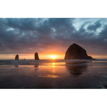 Sunset behind Haystack Rock at Cannon Beach on the Pacific Northwest coast, Oregon, United States o Print Wall Art By Martin