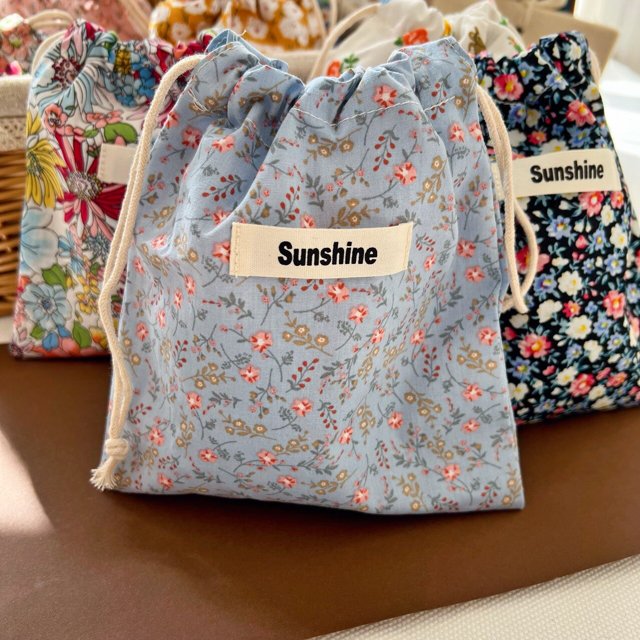 Bolsas de pañales con estampado de flores para mamá, bolsa de almacenamiento de pañales de algodón para bebé, bolsillo de cuerda para cochecito, paquete de transporte, viaje al aire libre