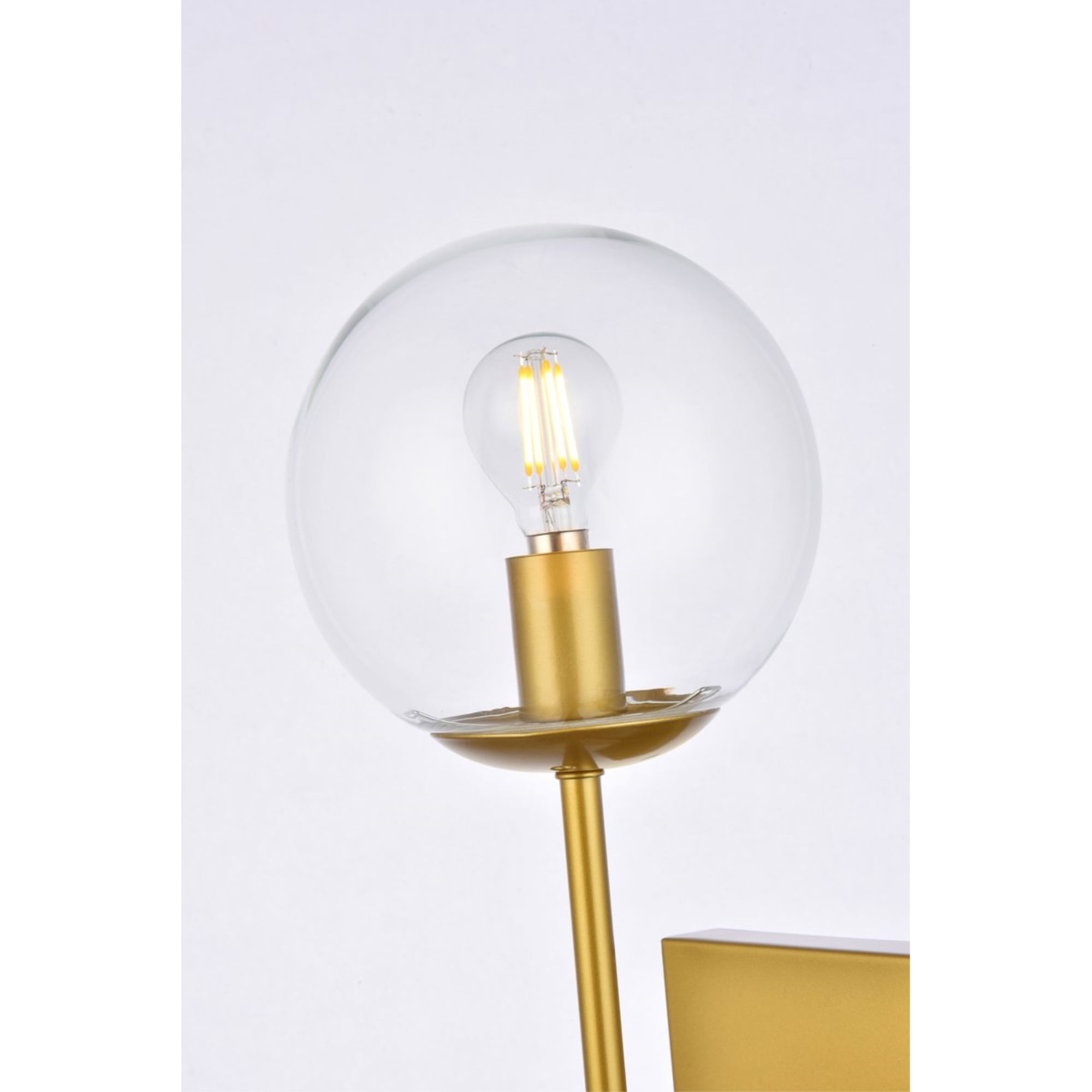 Neri 1 light brass and clear glass wall sconce