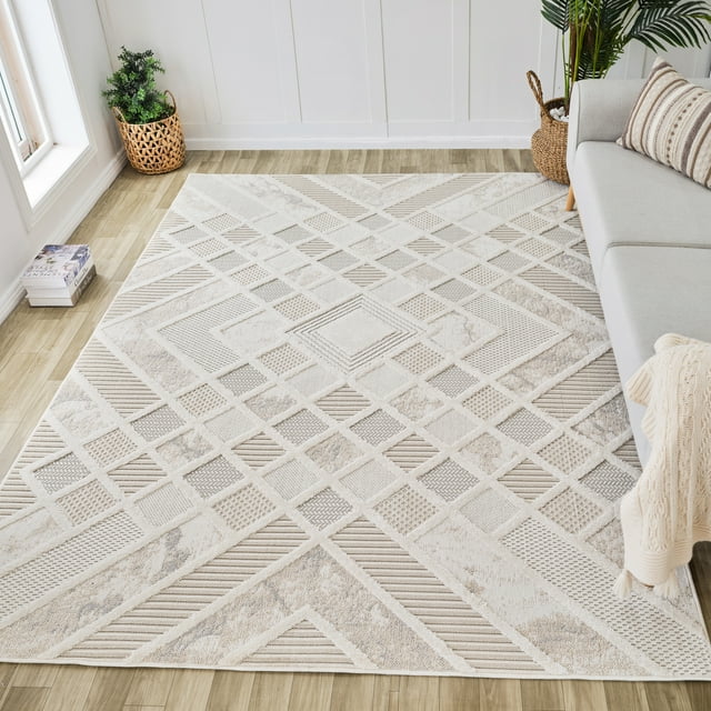 Modern cream beige indoor area rug with geometric patterns on light wood floor next to gray sofa and plants.