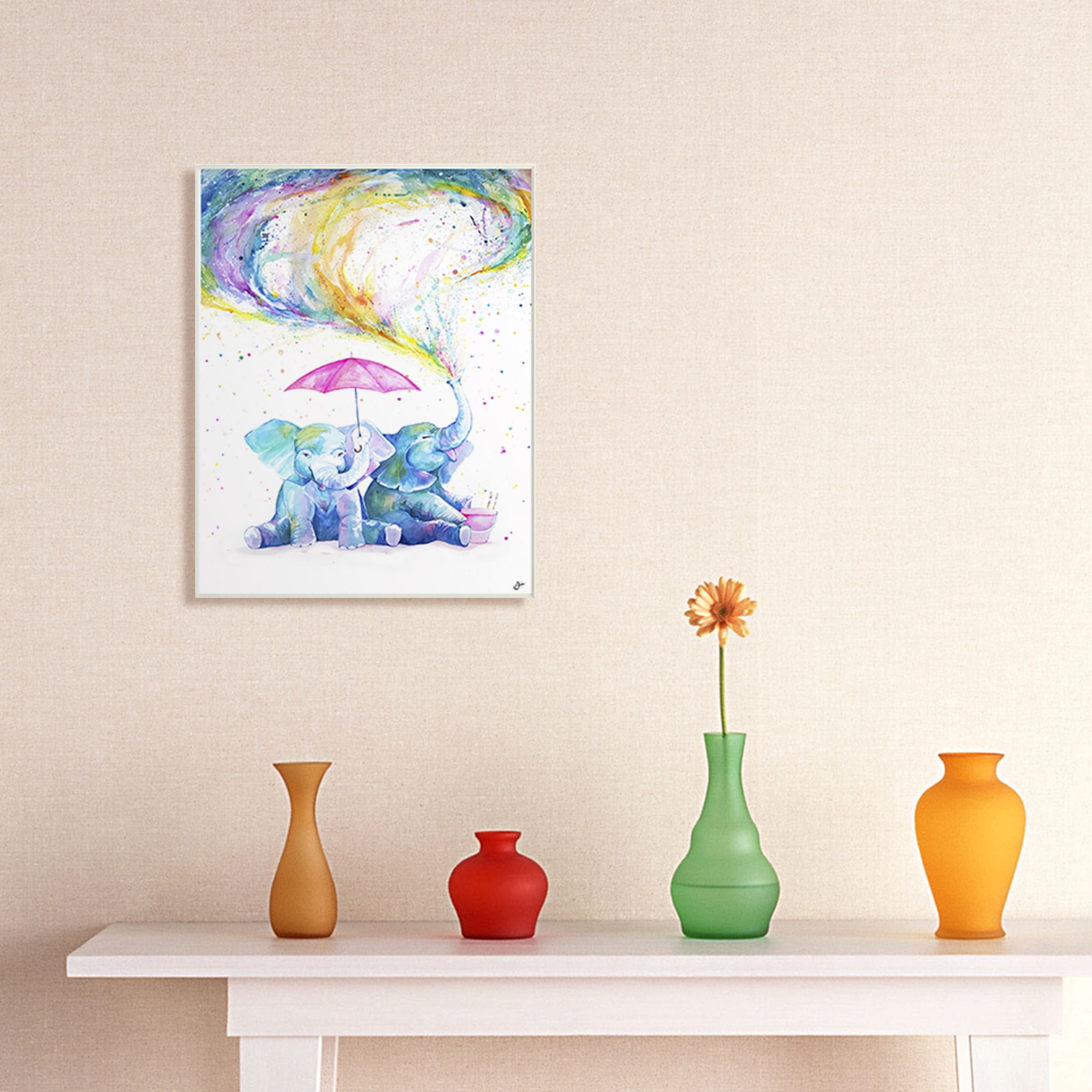 The Stupell Home Decor Rainbow Watercolor Spraying Elephants with Pink Umbrella Wall Plaque Art