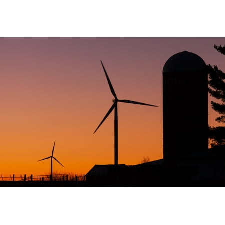 Elk Wind Energy Farm and a silo at sunrise near Edgewood Iowa United States of America