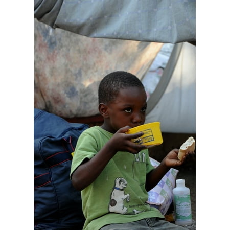 - LAMINATED POSTER A displaced Haitians child eats in a tent city near, the Presidential Palace in Port au Prince, Hait Poster Print 24 x 36