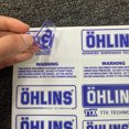 thumbnail image 2 of Autocollant Logo Étanche Ohlins Absorbeur de Chocs Moto Pare-Soleil Transparent Décoratif Universel, 2 of 4