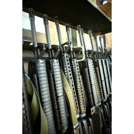 Assault rifles stand ready on the weapons rack Stretched Canvas - Stocktrek Images (23 x