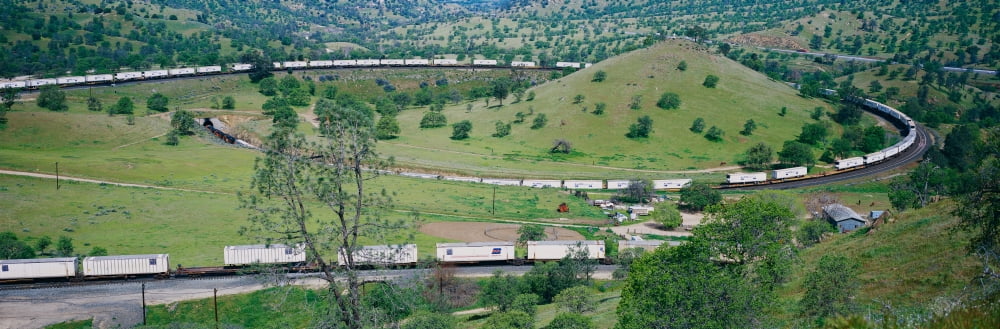 The Tehachapi Train Loop near Tehachapi California is the historic location of the Southern Pacific Railroad where freight trains gain 77 feet in elevation and show freight cars traveling in giant loo