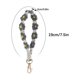 thumbnail image 2 of Llavero bohemio de flores tejidas a mano con colores contrastantes, pulsera y colgante para telfono., 2 of 7
