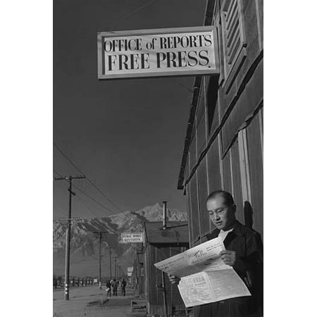 Roy Takeno reads a copy of the Manzanar Free Press in front of the newspaper office mountains in the background  Ansel Easton Adams was an American photographer best known for his black-and-white