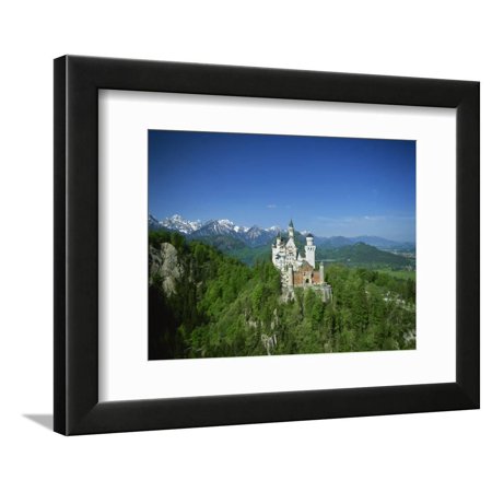 Neuschwanstein Castle on a Wooded Hill with Mountains in the Background, in Bavaria, Germany Framed Print Wall Art