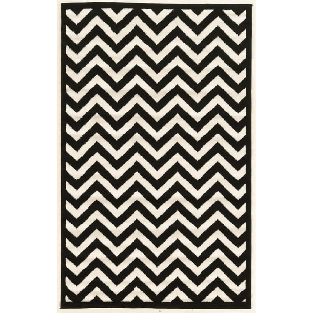 Capri Chevron black and cream area rug measuring 4 feet 3 inches by 7 feet 3 inches featuring bold zigzag stripes.