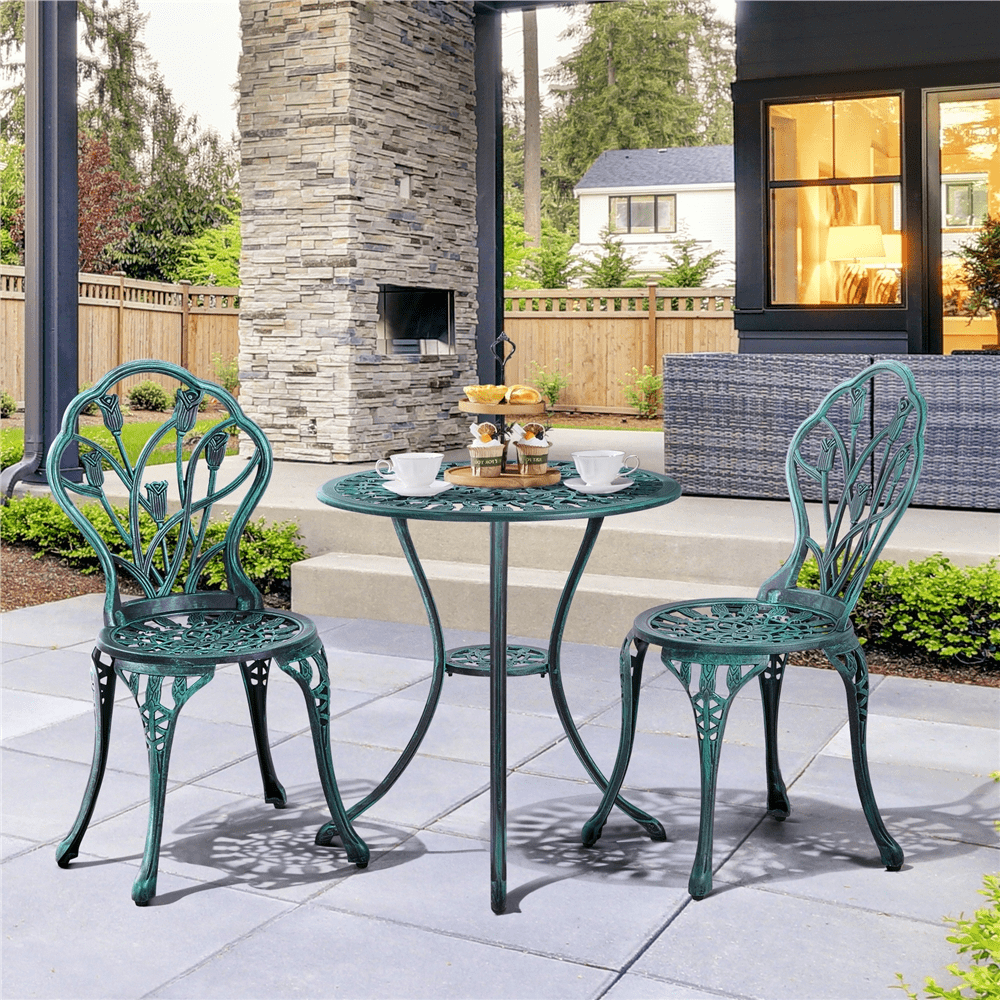 green wrought iron table and chairs