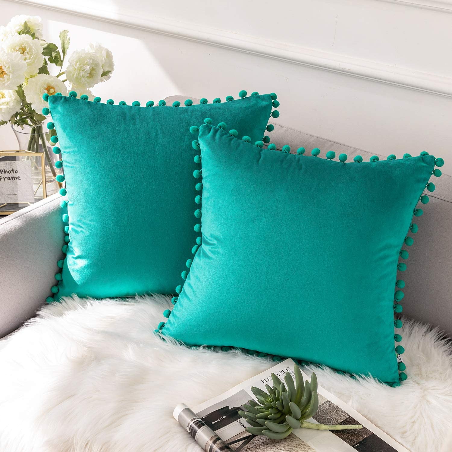 teal pom pom cushion