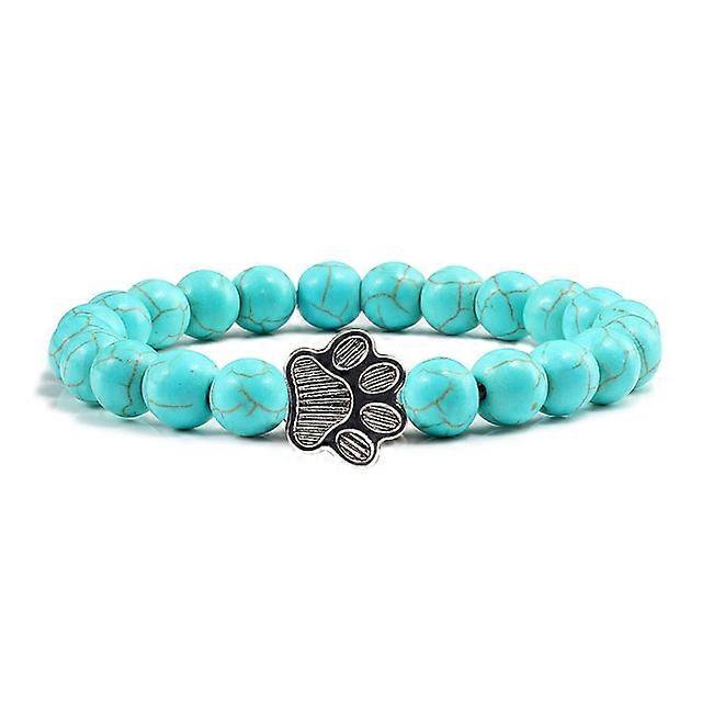 Pulsera con dije de huella de pata de piedra volcánica de lava negra mate natural, ideal como recuerdo para mascotas, amantes de los gatos y los perros.