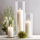 thumbnail image 1 of Juego de 12 velas de pilar blancas con jarrones cilíndricos de vidrio, 1 of 7