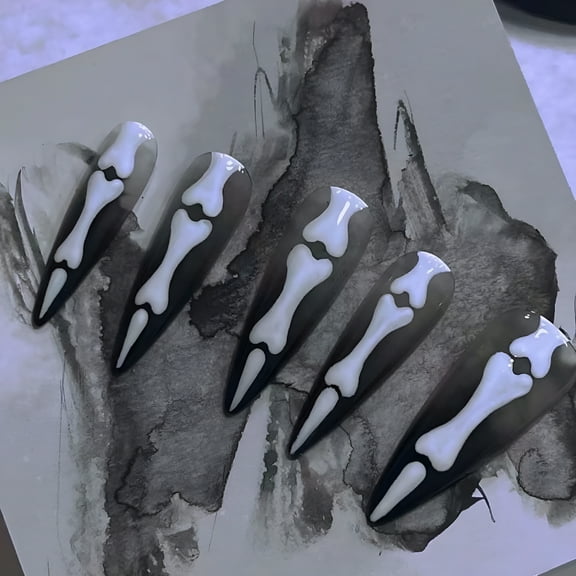 RAGUPEL Long Stiletto Fake Nails, Halloween Press on Nails, Black False Nails with White Bone Designs, Acrylic Nails Press on Artificial Glue on Nails Full Cover Stick on Nails for Women Girls