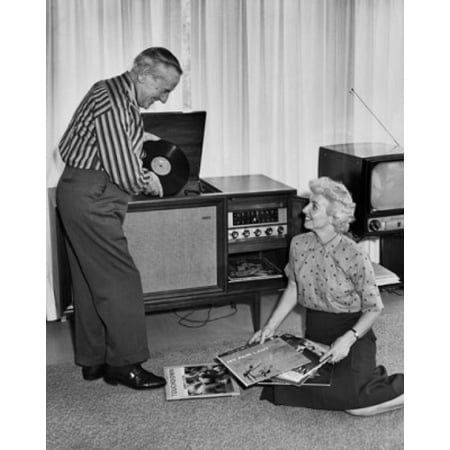 Senior couple listening to music from vinyl records Canvas Art - (24 x 36)