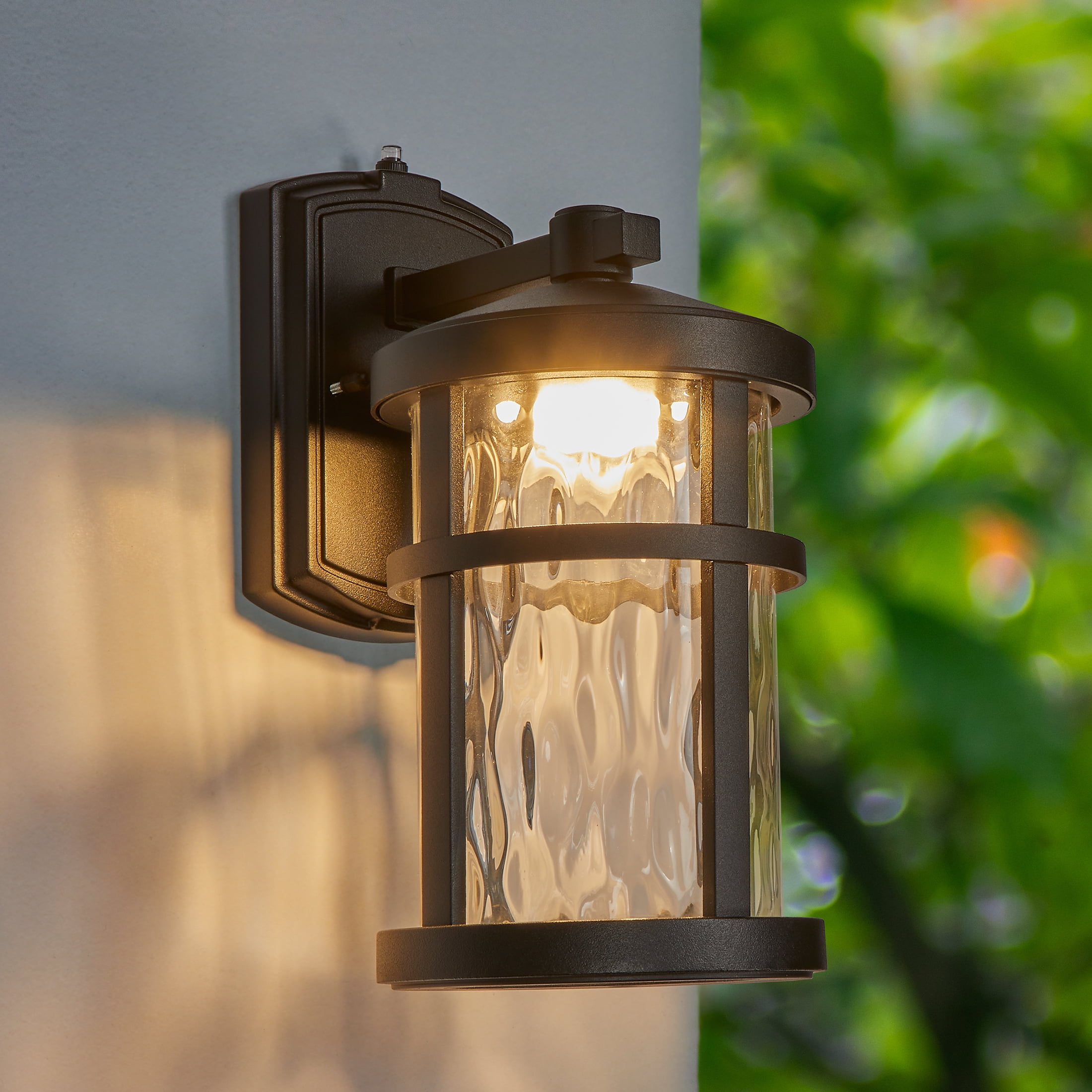 Maxxima LED Outdoor Wall Light, Black Finish, Clear Hammered Glass, Dusk to Dawn Sensor, 750 Lumens, 3000K Warm White