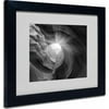 Matted art under acrylic in a black frame