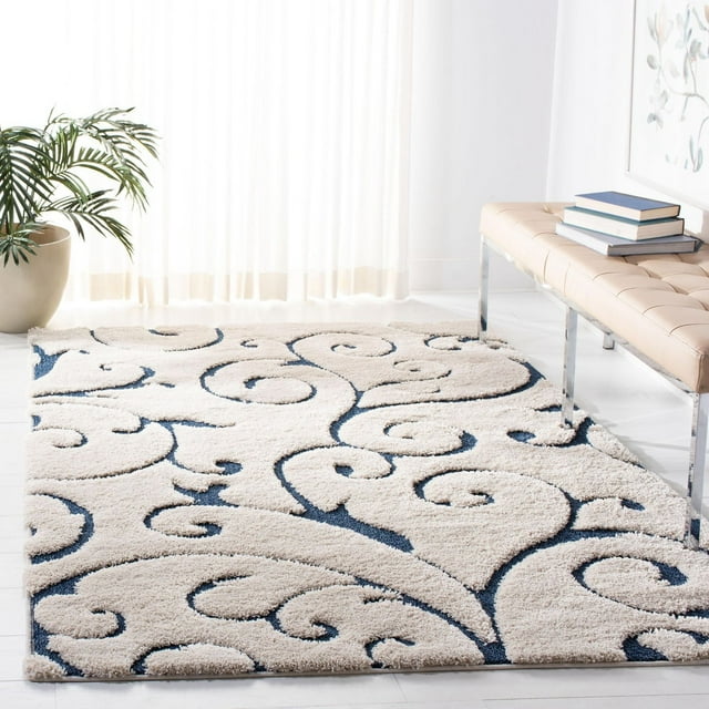 SAFAVIEH Florida Douglas shag area rug featuring cream color with dark blue floral vine design, displayed in a modern living space.