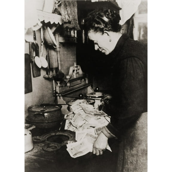 German Women Burning Money To Fuel Her Stove During The Post World War I Hyper-Inflation In 1923. At The Time History