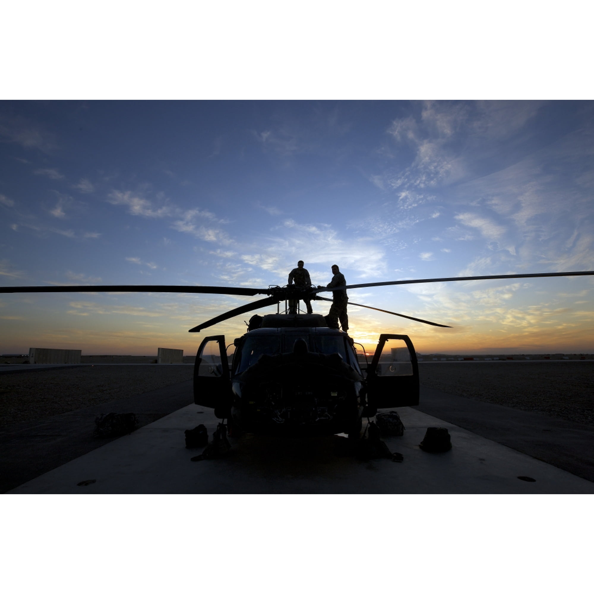 A UH-60 Black Hawk helicopter on the flight line at sunset Canvas Art - Terry MooreStocktrek Images (18 x 12)