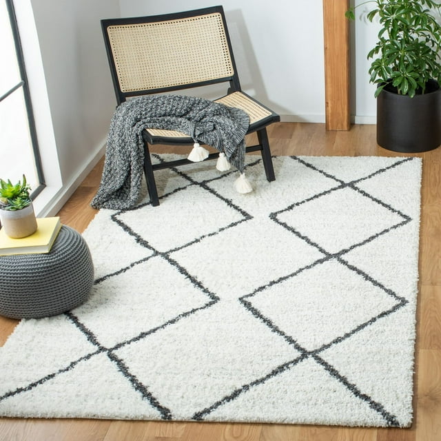 SAFAVIEH August Melanie white shag area rug with black geometric diamond pattern in modern room setting