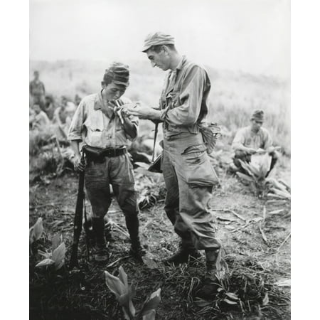 US Soldier Of Lights A Cigarette For A Former Enemy Guard They Are At A Surrender Conference Between American And Japanese Officers On A Sierra Madre Mountain Top In Northern Luzon