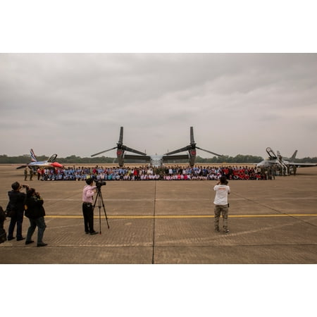 - LAMINATED POSTER U.S. service members, Royal Thai Air Force members and local children take a photo in front of an F- Poster Print 24 x 36