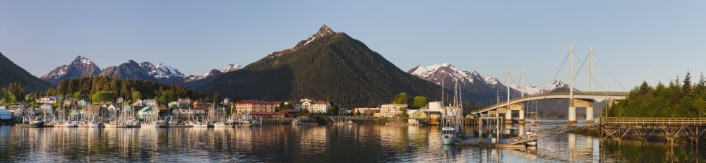 Downtown Sitka and the OConnell bridge on a clear summer evening Sitka harbour and docked fishing boats in the foreground the Sisters Mountains with snow on the peaks in the background Sitka Alaska Un