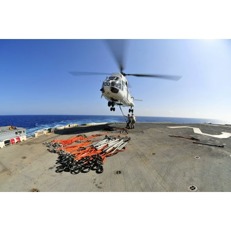 South China Sea October 27 2011 - Airmen attach pallet rigs to an SA-330J Puma helicopter abord the forward-deployed amphibious assault ship USS Essex during a replenishment at sea Poster