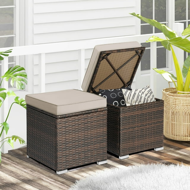 Gymax 2PCS Outdoor Patio Ottomans with hand-woven mix brown PE wicker and beige removable cushions. Each ottoman measures 16'' x 16'' x 15.5'' and features hidden storage space accessible via hinged tops. Versatile design allows use as footstools, side tables, or additional seating. Built with a sturdy steel frame and raised feet for outdoor durability.