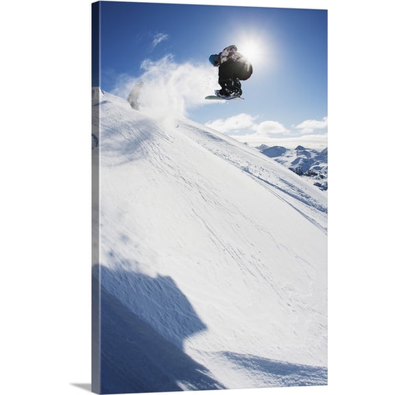 Great BIG Canvas | "Professional snowboarder making a jump in fresh snow near Ushuaia, Patagonia, Argentina" Canvas Wall Art - 24x36
