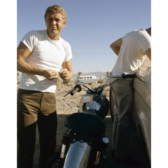 Steve McQueen in white t-shirt stands next to bike in desert 1960's 5x7 photo