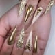 thumbnail image 1 of Uñas postizas largas de aguja con diamantes de imitación, purpurina dorada, acrílico brillante, juego reutilizable de 24 piezas., 1 of 5