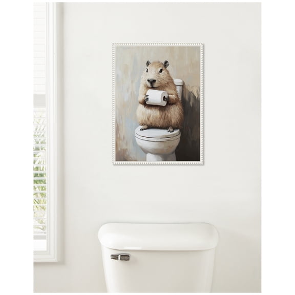 Kate and Laurel Capybara Angled Holding Toilet Paper Roll Toilet Bathroom Art Framed Canvas Wall Art by The Creative Bunch Studio 18 x 24 Sylvie Beaded White, Whimsical, Animals, Bathroom, Humor Art
