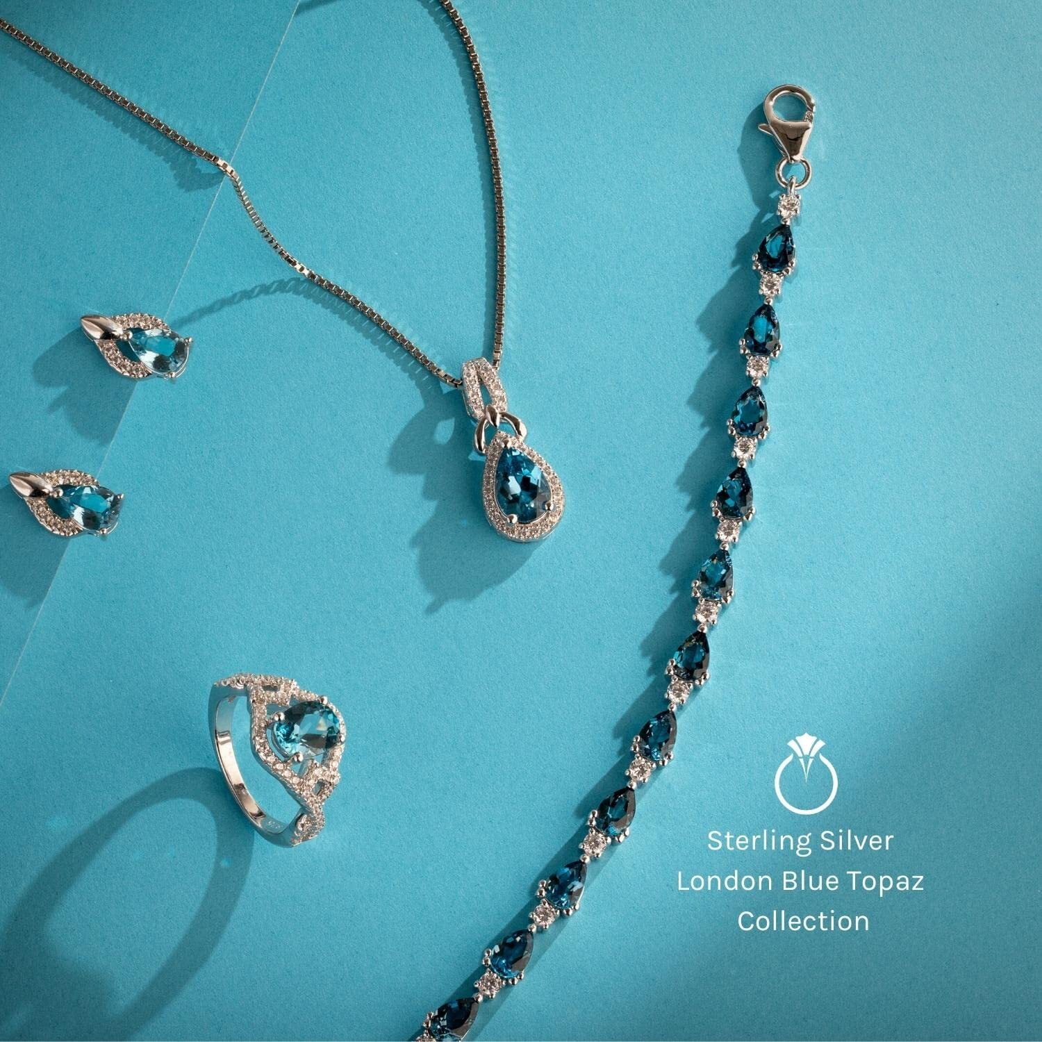 Peora London Blue Topaz Stud Earrings 925 Sterling Silver, Solitaire Scroll Gallery, 1.50 Carats Total, Trillion Cut, 6mm, Friction Back