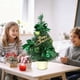 thumbnail image 1 of Adorno navideño retráctil mini de 30 cm | Decoración navideña de escritorio | Árbol de mesa de plástico ensamblado a mano con lazos y adornos navideños | Dorado, rojo, azul y verde, 1 of 6