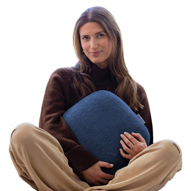 Quiet Mind The Original Weighted Pillow for Adults in medium size and blueberry color, weighing 9 lbs. This square-shaped weighted body pillow is designed for stress relief and relaxation, featuring a soft, plush texture and a compact design. The pillow is held by an individual seated cross-legged, showcasing its portable and versatile nature. Made with repurposed glass beads, memory foam, and a durable polyester cover, it offers a cooling effect and deep pressure stimulation for enhanced comfort and sleep. Ideal for use on the couch, bed, or during travel.