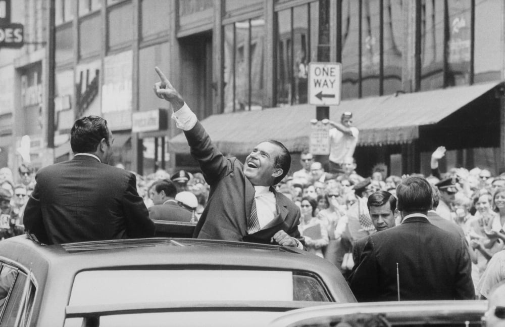 President Nixon Pointing At The Crowd From The Roof Of His Car During A