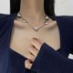 thumbnail image 2 of Collar colgante con colgante de alas de ángel y bola dorada Yashi Gris, 2 of 4