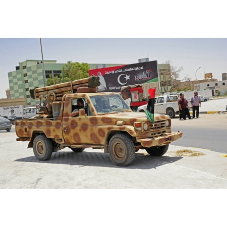 A Free Libyan Army pickup truck equipped with a homemade rocket Poster