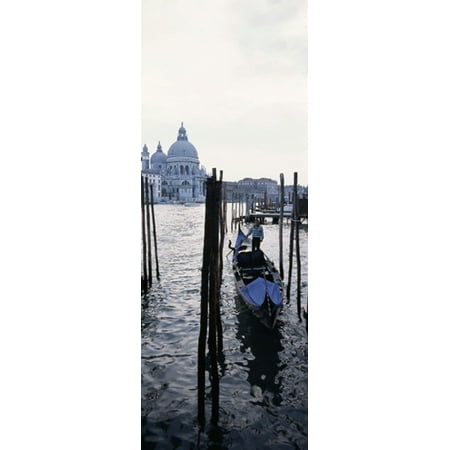 Gondolier in a gondola with a cathedral in the background Santa Maria Della Salute Venice Veneto Italy Stretched Canvas - Panoramic Images (18 x