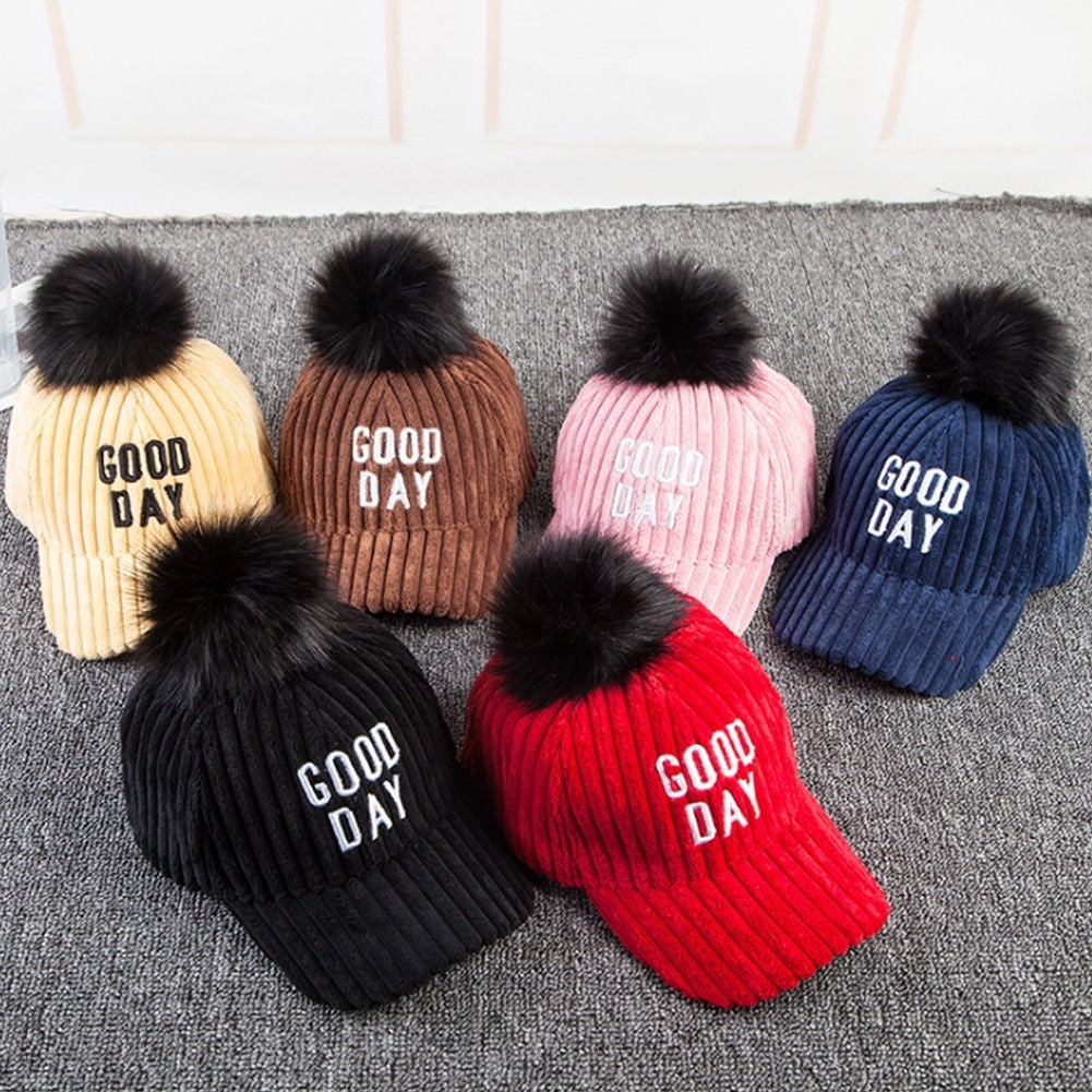 baseball cap with fur pom pom