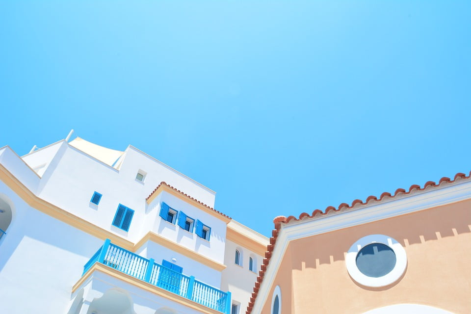 Colorful Building and Bright Blue Sky Poster