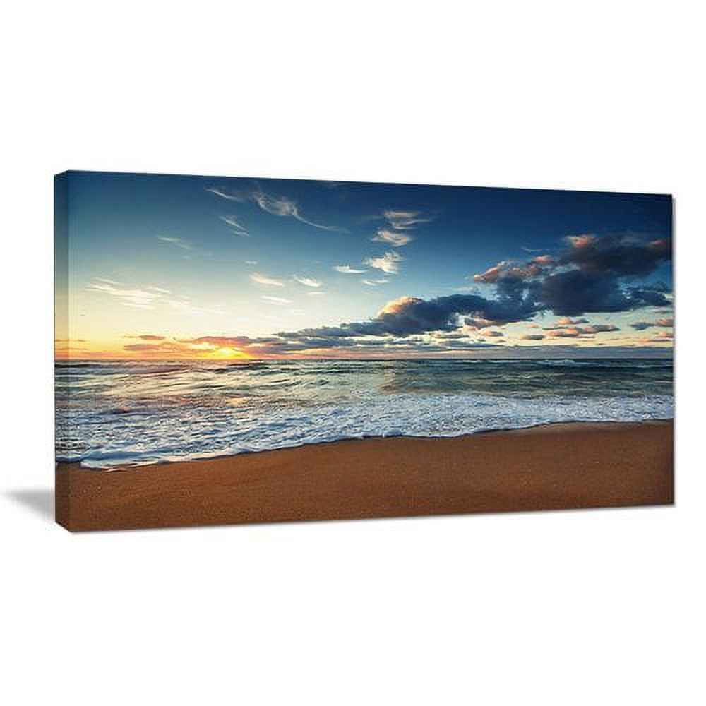 Designart 'Sunrise and Glowing Waves in Ocean ' Seascape Canvas Art Print