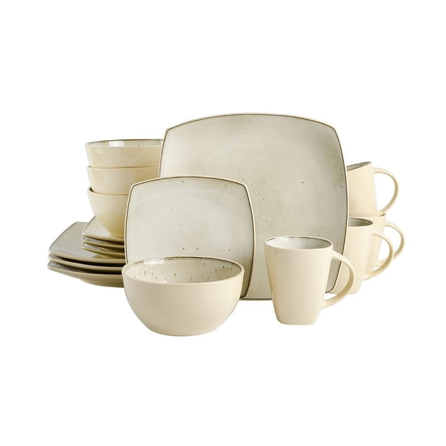 vajilla gibson elite cuadrada 16 piezas cerámica Cream White para 4 personas; platos, cuencos y tazas de cerámica color crema con acabado esmaltado y borde ligeramente oscuro, diseño cuadrado y redondeado apilado sobre fondo blanco, adecuada para uso diario y ocasiones especiales, también se usa frecuentemente para mesas informales y reuniones pequeñas.